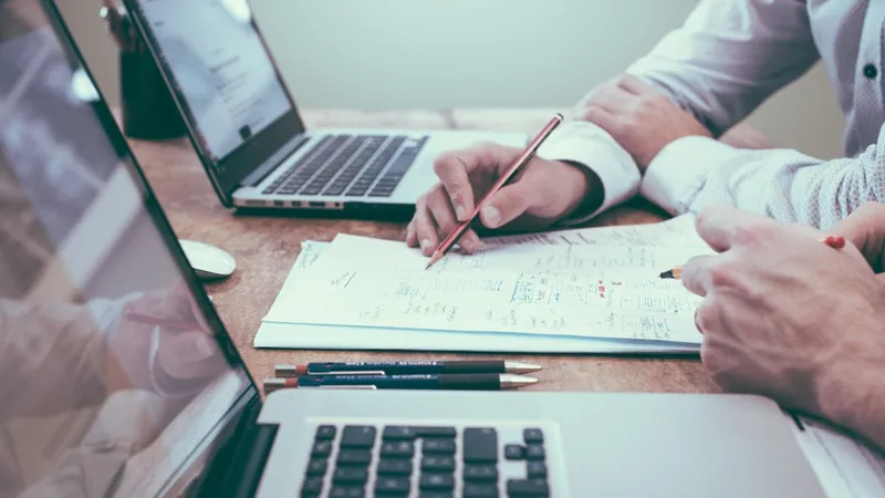 A scorecard and pen on a conference table mid-evaluation