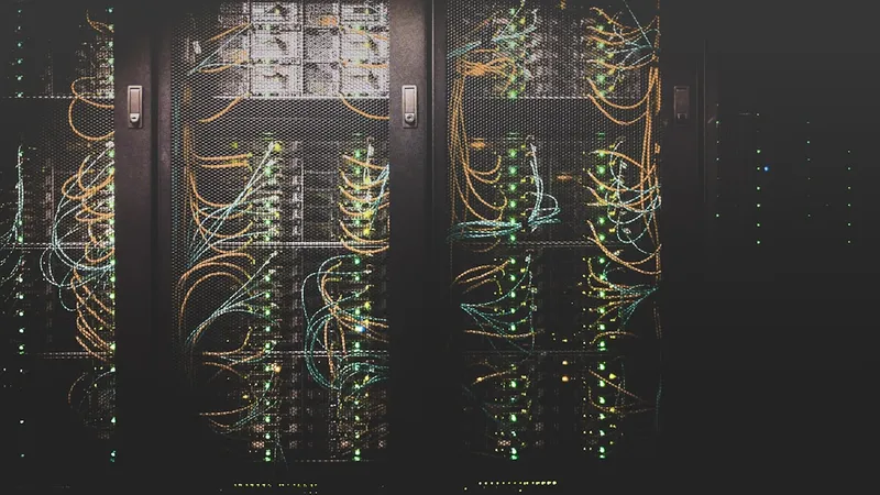 Server room corridor with blue-lit rack hardware, representing IT infrastructure project scope